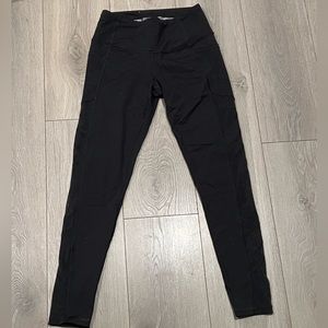 Black leggings with mesh-design on leg.